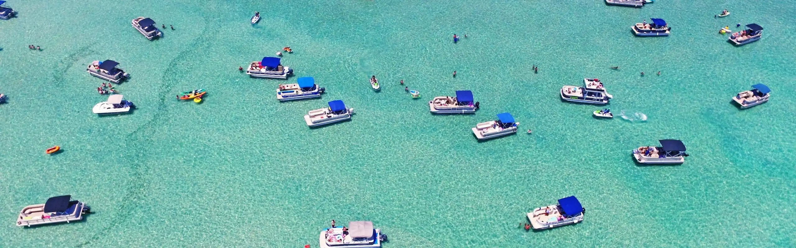 Boats gathered at Crab Island on a clear day in Destin, Florida